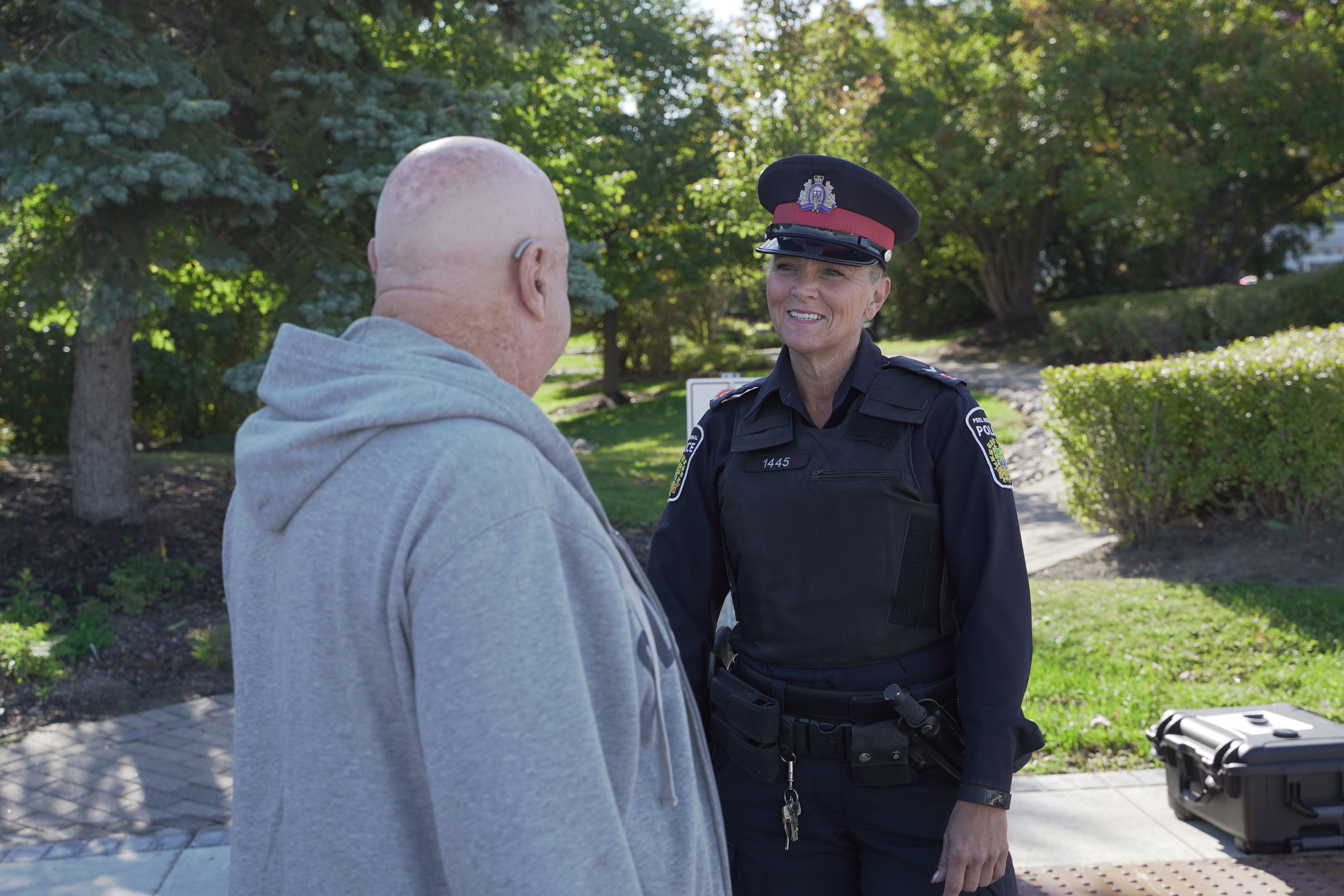 Senior citizen man talks to police officer