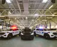 3 police vehicles parked in large garage