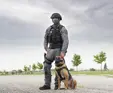 officer standing beside K9