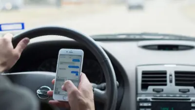 Driver on cellphone one hand