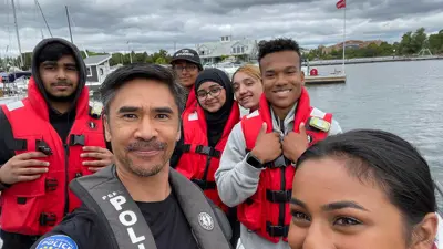 YIPI students and officer wearing lifejackets at waterfront