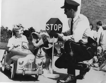 Officer teaching car safety lesson