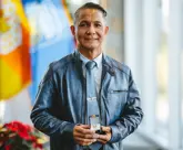 Award recipient holding a pin