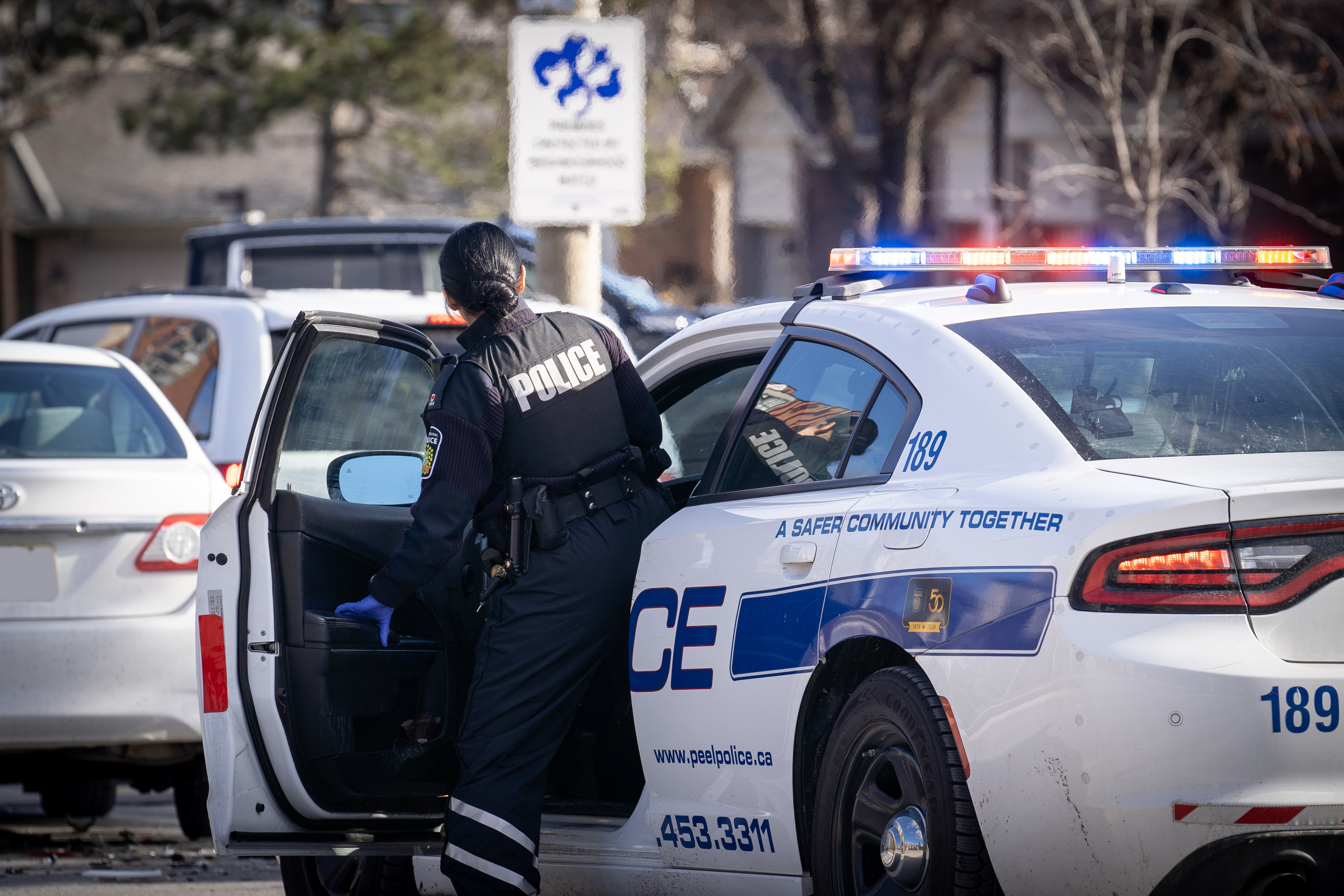 Female Peel Police Officer getting into police car