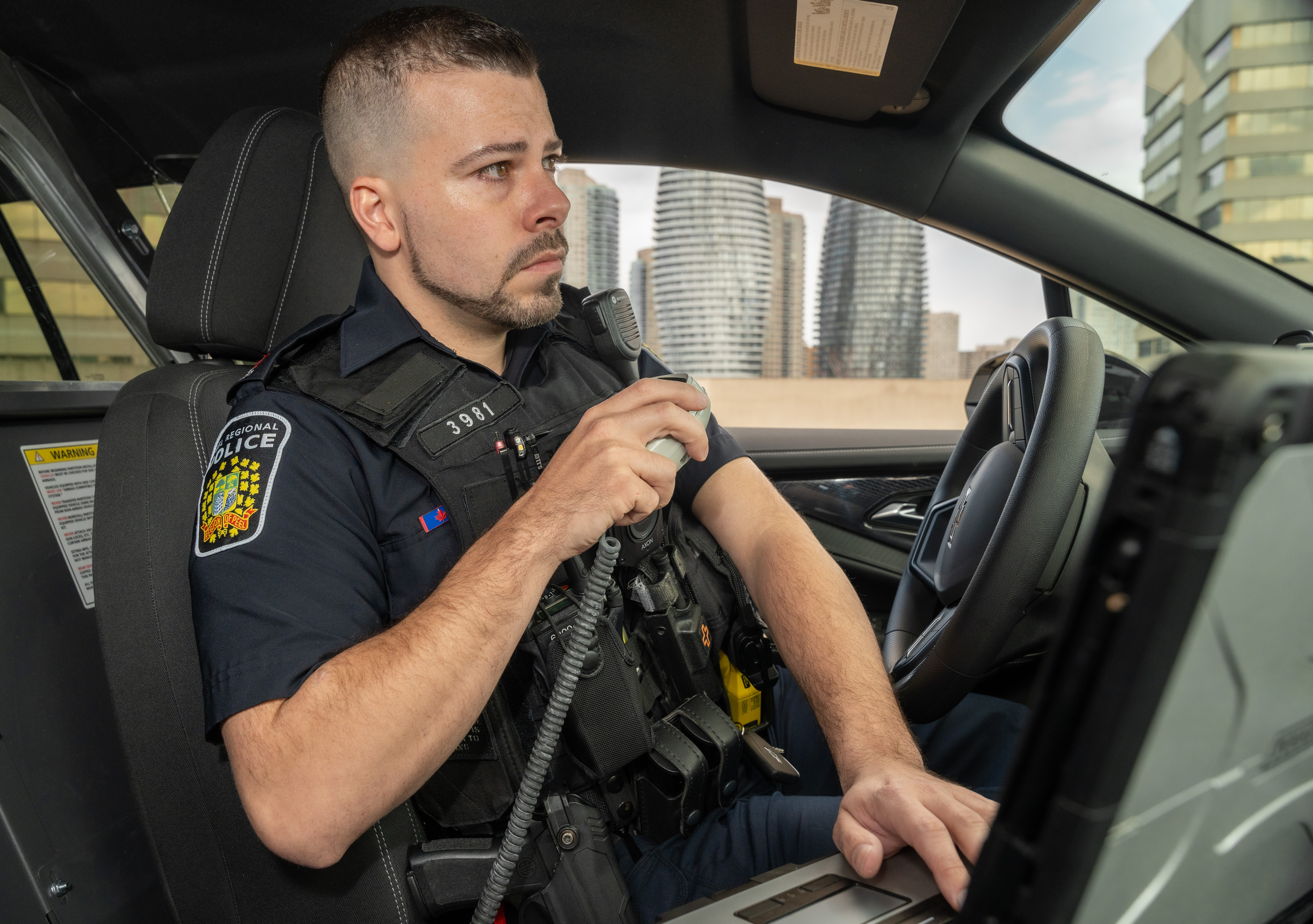 Peel Police officer talking on radio inside cruiser
