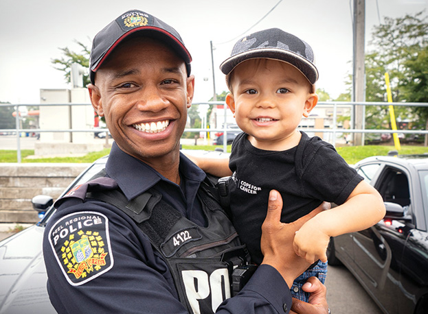 Male police officer holding baby