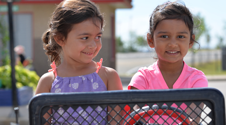 two young girls in toy Jeep