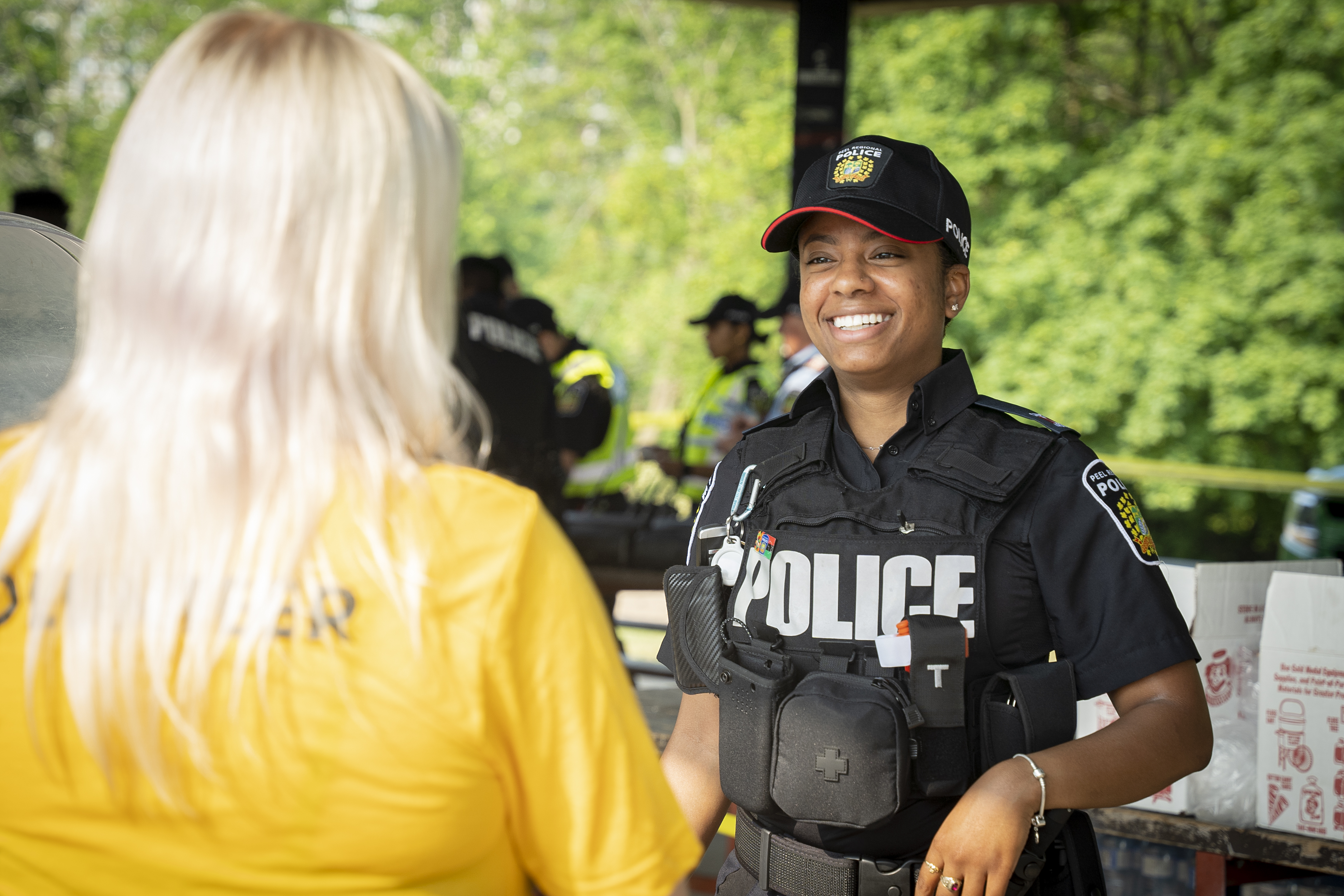 Female police officer smiling at female