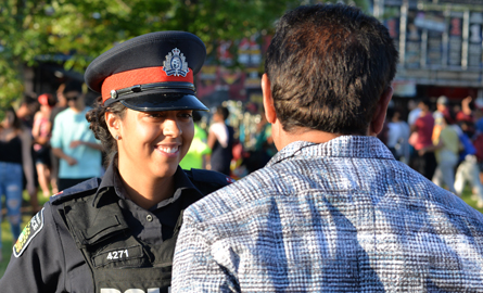officer smiling while speaking to member of the community