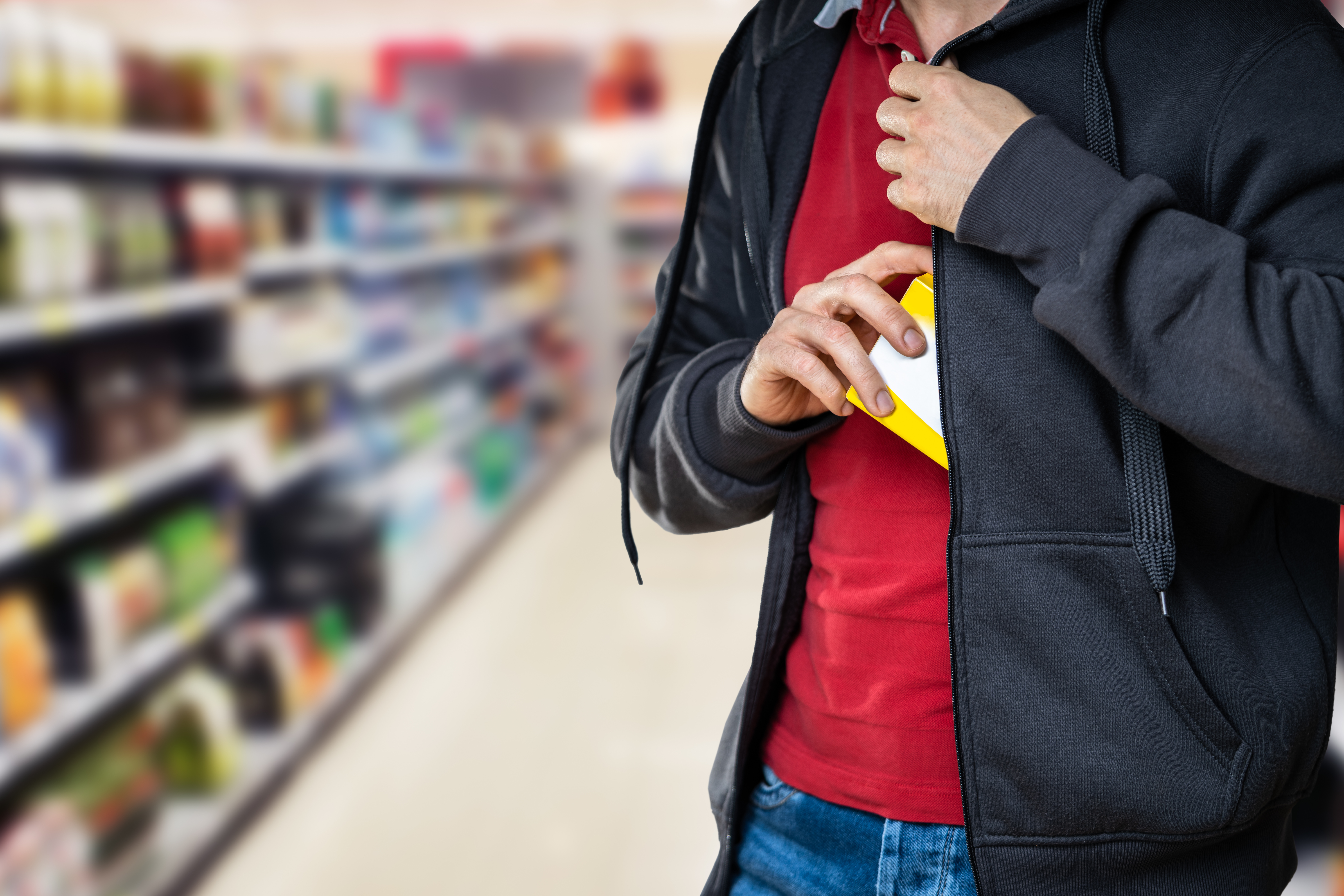 Person stuffing product in jacket