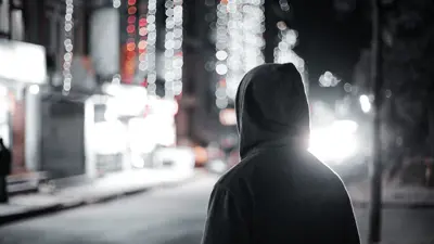 Hooded person in dark