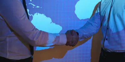 Handshake With Map Of The World In Background