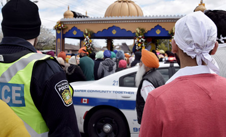 Employee and member of public watching a parade