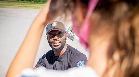 Police officer smiling at young girl