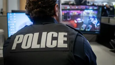 Police officer reviewing aerial video footage