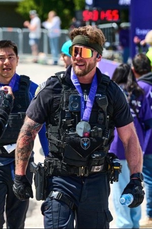 Police officer wearing marathon medal