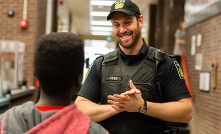 Employee talking and smiling with a young child