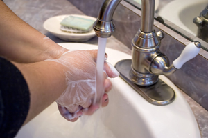 a-person-washing-and-rinsing-off-their-hands-in-the-bathroom-sink_rYw9SOCHo