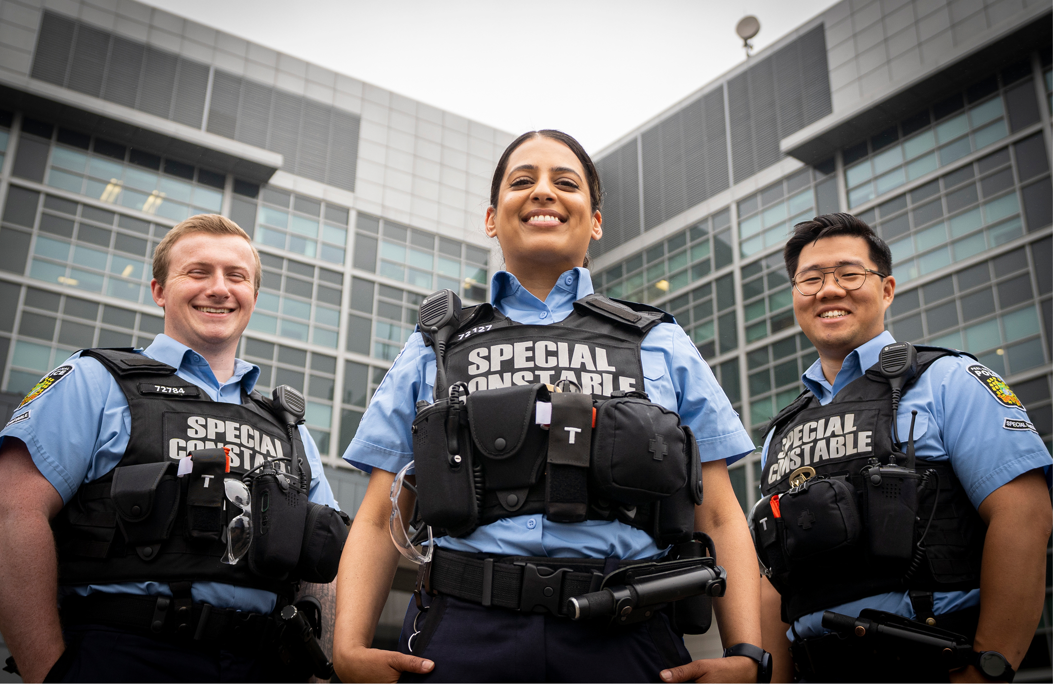 Special constables smiling outside courthouse