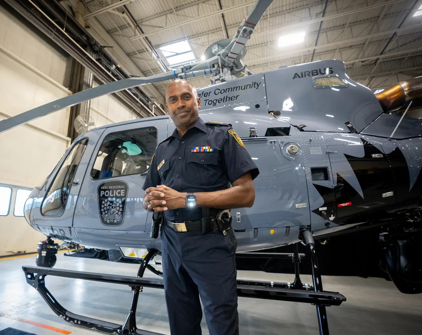 Chief of Police with helecopter in hangar
