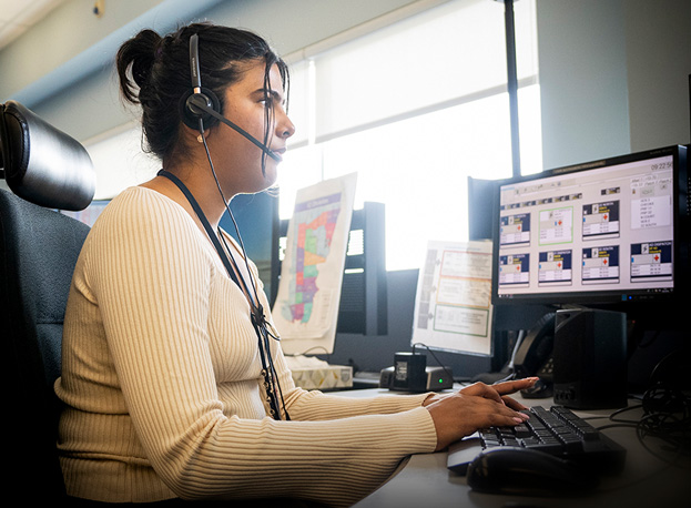 911 communicator wearing headset while taking a call